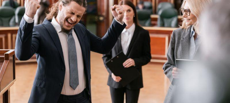 Man in court celebrating drug possession charges being dropped